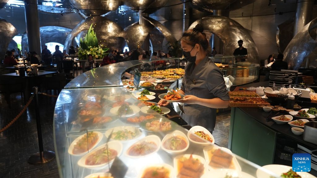 A staff member arranges dishes at a morning tea restaurant in Wuzhong, northwest China's Ningxia Hui Autonomous Region, Sept. 21, 2026. Nestled along the banks of the Yellow River, Wuzhong has cultivated a unique culinary culture through centuries of trade and cultural exchange.(Xinhua/Liu Hai)