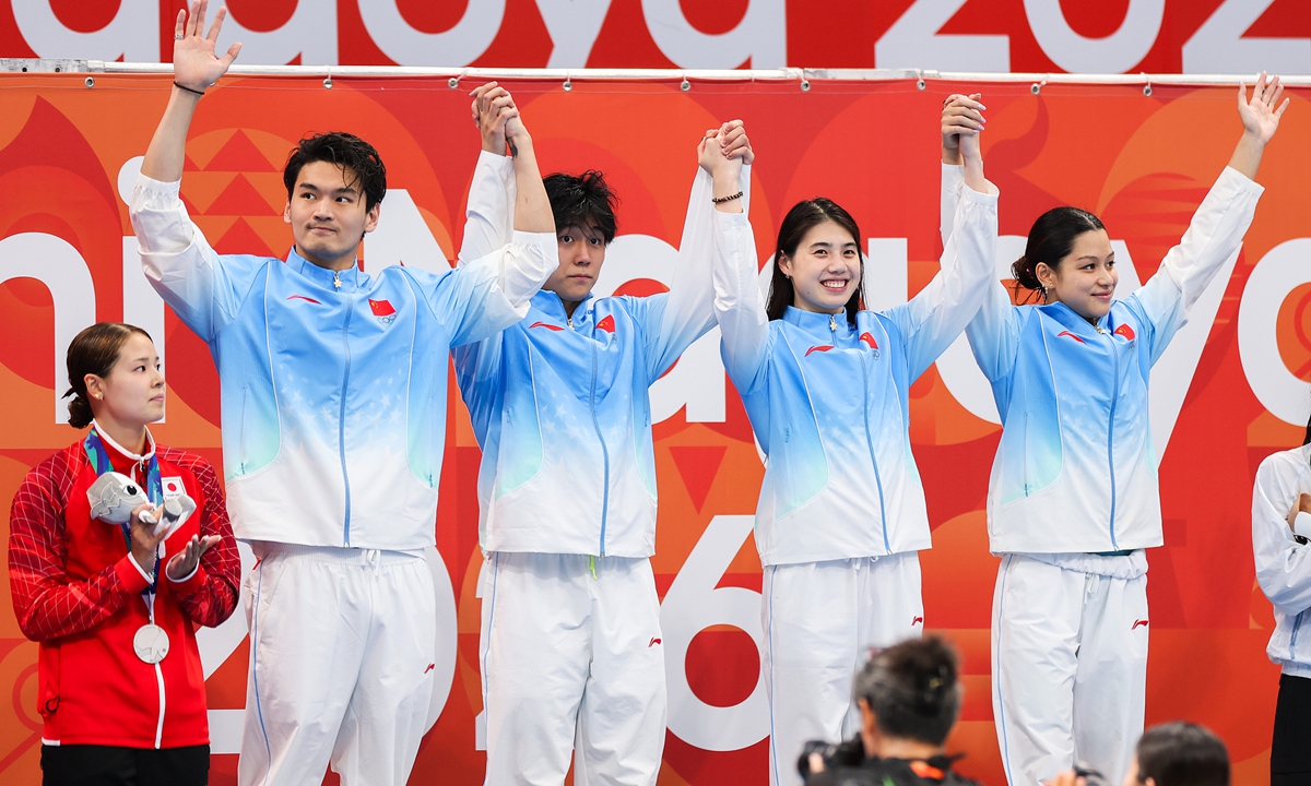 China's Xu Jiayu, Dong Zhihao, Zhang Yufei and Yu Yiting (from left to right) celebrate after winning the mixed 4x100-meter medley relay final at the 2026 Nagoya Asian Games in Nagoya, Japan, on September 23, 2026. 
Photo: VCG
