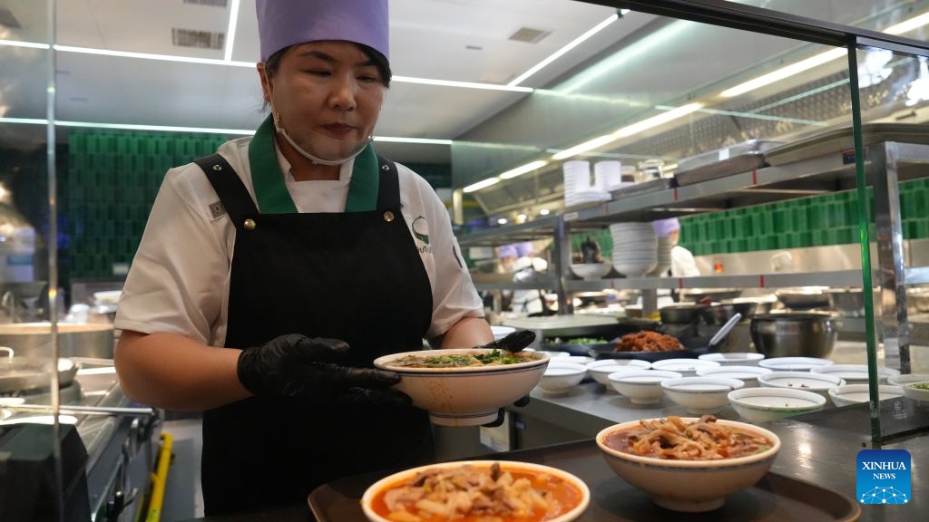A staff member serves dishes at a morning tea restaurant in Wuzhong, northwest China's Ningxia Hui Autonomous Region, Sept. 21, 2026. Nestled along the banks of the Yellow River, Wuzhong has cultivated a unique culinary culture through centuries of trade and cultural exchange.(Xinhua/Liu Hai)