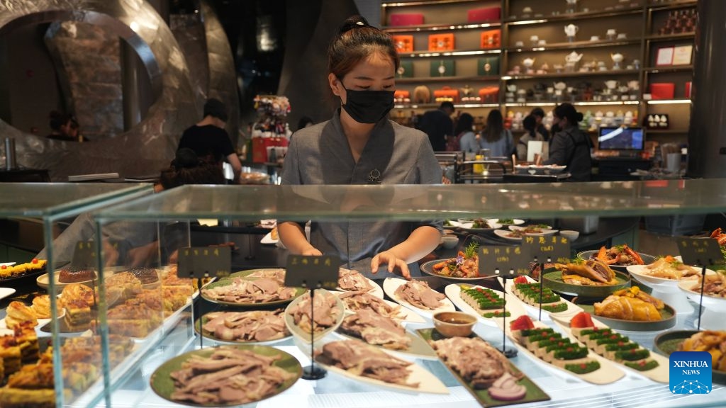 A staff member arranges dishes at a morning tea restaurant in Wuzhong, northwest China's Ningxia Hui Autonomous Region, Sept. 21, 2026. Nestled along the banks of the Yellow River, Wuzhong has cultivated a unique culinary culture through centuries of trade and cultural exchange.(Xinhua/Liu Hai)