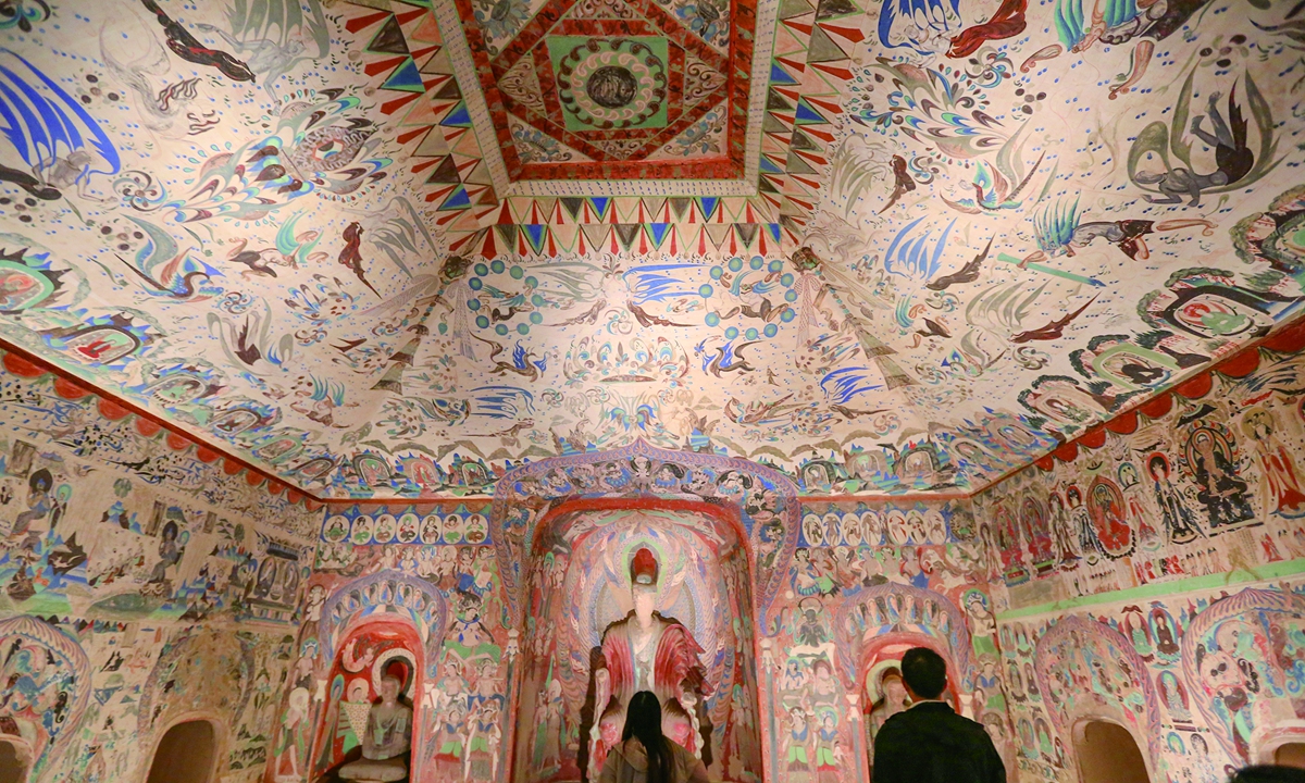 Visitors admire the murals at the Mogao Caves in Dunhuang, Northwest China's Gansu Province Photo: VCG