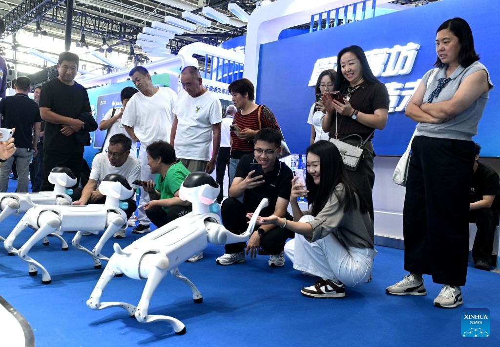 People interact with robot dogs at the China International Digital Economy Expo 2026 in Shijiazhuang, north China's Hebei Province, Sept. 23, 2026. The China International Digital Economy Expo 2026 opened on Wednesday at the International Convention and Exhibition Center in Shijiazhuang. The three-day expo features four major sections including themed exhibitions, industry exchanges, professional competitions and digital-themed activities. (Photo: Xinhua)