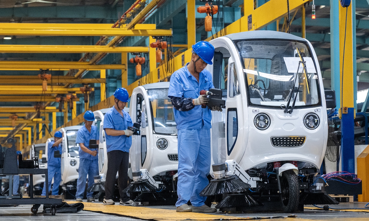 Workers assemble new-energy street sweepers at a workshop in Fanchang Economic Development Zone in Wuhu, East China's Anhui Province, on September 23, 2026. Factories across the region have been busy fulfilling orders to meet booming market demand. Photo: VCG