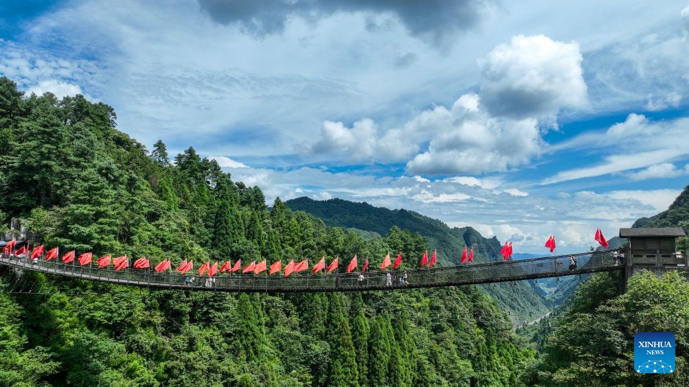 A drone photo shows the Changkong Bridge, a suspension footbridge in the Loushan Pass scenic area in Huichuan District of Zunyi City, southwest China's Guizhou Province, Aug. 6, 2026. This year marks the 90th anniversary of the victory of the Long March. Guizhou, where the Red Army regrouped and thrived during its most challenging times, has harnessed the Long March spirit to drive its development. (Photo: Xinhua)