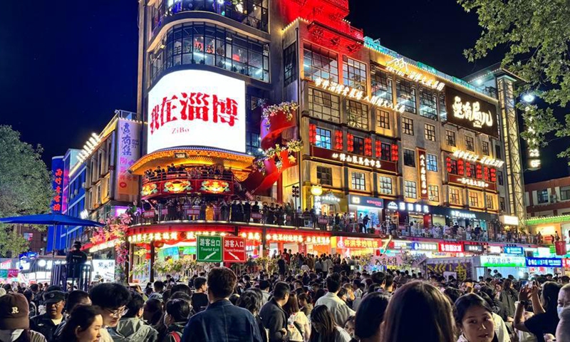 People visit Badaju Market, a traditional neighborhood market, in Zibo, east China's Shandong Province, May 3, 2025. (Xinhua/Wu Qinghao)