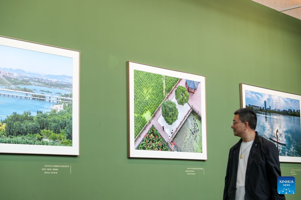 A man visits a photo exhibition focused on the achievements of China's urban construction in Beijing, capital of China, Sept. 23, 2026. The exhibition displays nearly 200 photographs taken by Xinhua photographers, offering a visual narrative of China's urban construction. (Xinhua/Li Xulun)