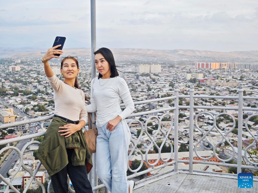 This photo taken with a mobile phone shows people taking selfies on Sulayman Mountain in Osh, Kyrgyzstan, on Sept. 23, 2026. (Xinhua/Ding Lei)