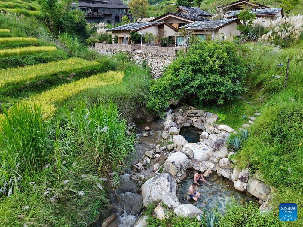 A drone photo taken on Sept. 23, 2026 shows people enjoying leisure time at a hot spring resort in Hewei Village of Changning County in Baoshan City, southwest China's Yunnan Province. In recent years, Baoshan has been developing wellness tourism around its abundant hot spring resources, attracting visitors from neighboring cities and other parts of China. (Photo by Xue Yingying/Xinhua)