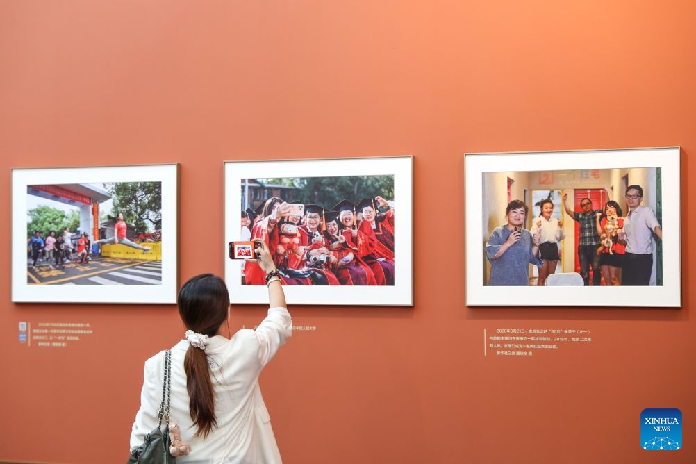 A woman visits a photo exhibition focused on the achievements of China's urban construction in Beijing, capital of China, Sept. 23, 2026. The exhibition displays nearly 200 photographs taken by Xinhua photographers, offering a visual narrative of China's urban construction. (Xinhua/Li Xulun)