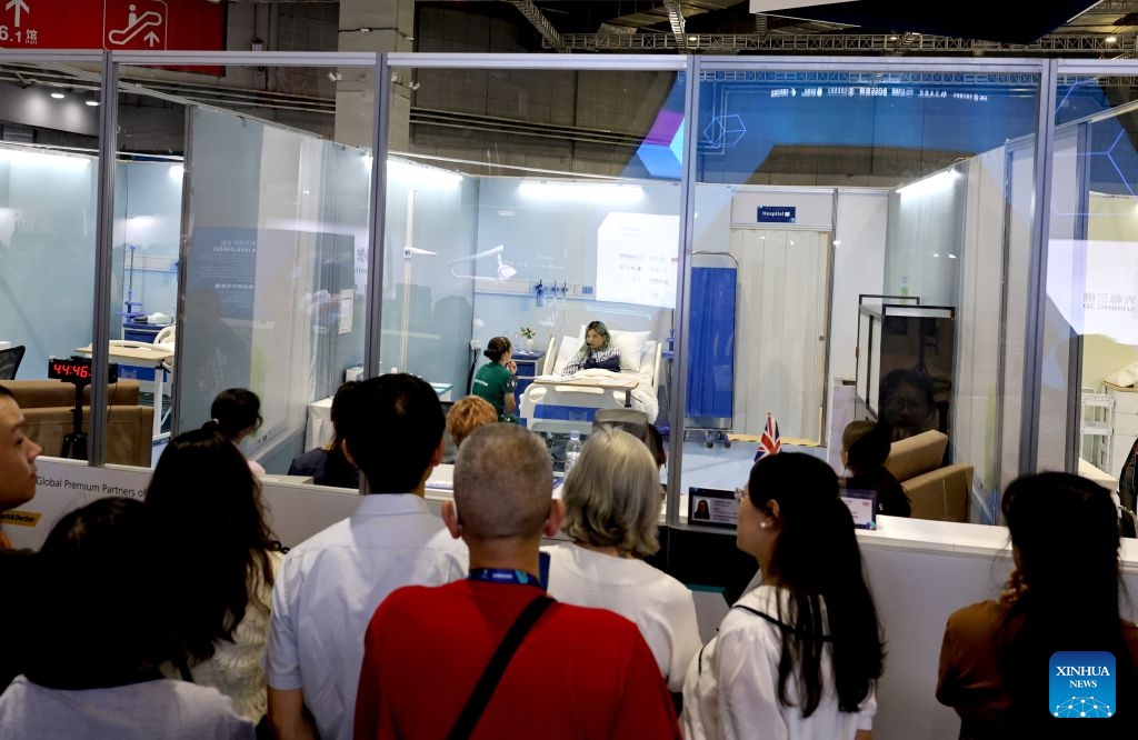 Visitors watch contestants participating in the health and social care event during the 48th WorldSkills Competition in east China's Shanghai, Sept. 24, 2026. The 48th WorldSkills Competition, currently being held at the National Exhibition and Convention Center (Shanghai), has attracted a large number of visitors. (Xinhua/Fang Zhe)