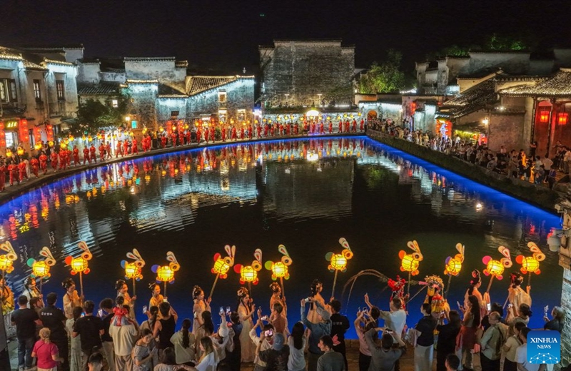A drone photo taken on Sept. 24, 2026 shows performers parading with rabbit-shaped lanterns in Hongcun Village, Yixian County of Huangshan City, east China's Anhui Province. A lantern parade was held here in celebration of the Mid-Autumn Festival.

In recent years, Huangshan has been boosting its nighttime economy to unlock the local consumption potential. Photo: Xinhua