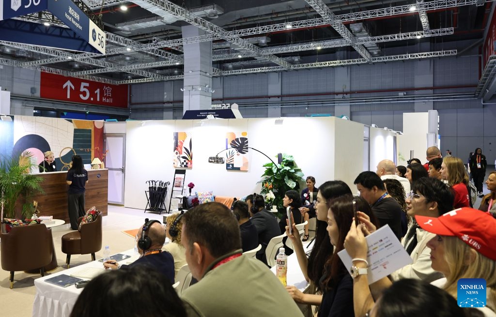 Visitors watch contestants participating in the hotel reception event during the 48th WorldSkills Competition in east China's Shanghai, Sept. 24, 2026. The 48th WorldSkills Competition, currently being held at the National Exhibition and Convention Center (Shanghai), has attracted a large number of visitors. (Xinhua/Fang Zhe)