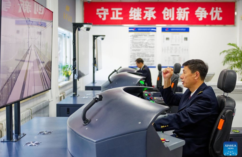An Electric Multiple Unit (EMU) driver conducts driving simulation training at a training center of China Railway Harbin Group Co., Ltd. in northeast China's Heilongjiang Province, Sept. 22, 2026. As the Harbin-Yichun high-speed railway, China's northernmost high-speed railway, enters the final countdown to opening, workers are carrying out intensive training, emergency drills, equipment inspections and surveying to ensure its safe operation.
With a designed speed of 250 kilometers per hour, the 318-km line will slash travel time between Harbin and Yichun from about seven hours to just two hours once it becomes operational. Photo: Xinhua