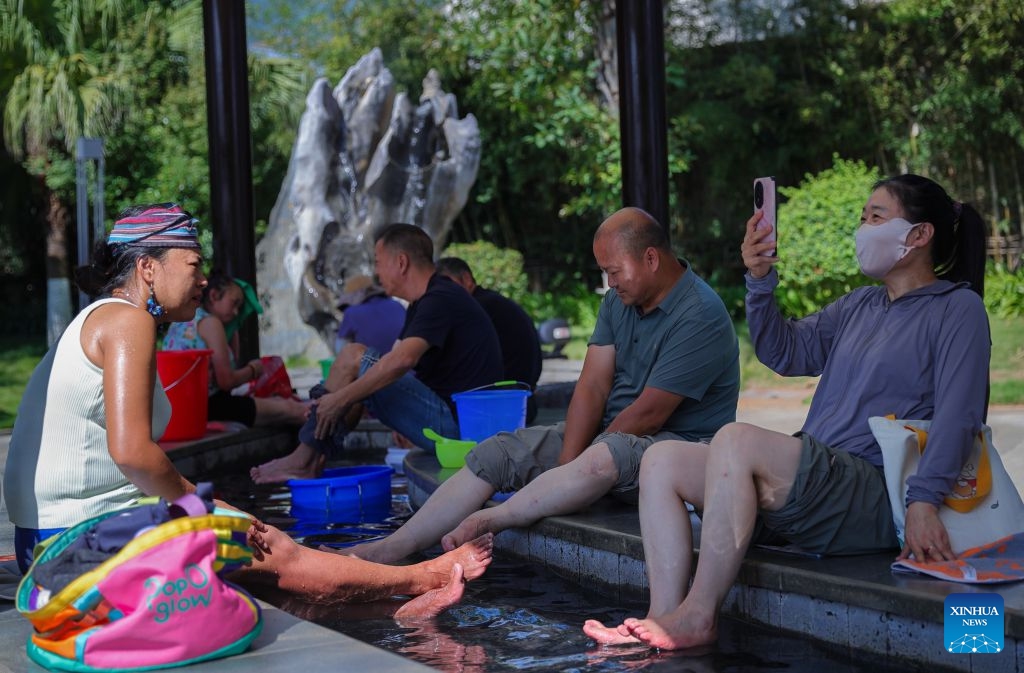People soak their feet at a hot spring resort in Changning County of Baoshan City, southwest China's Yunnan Province, Sept. 22, 2026. In recent years, Baoshan has been developing wellness tourism around its abundant hot spring resources, attracting visitors from neighboring cities and other parts of China. (Photo by Li Yi/Xinhua)