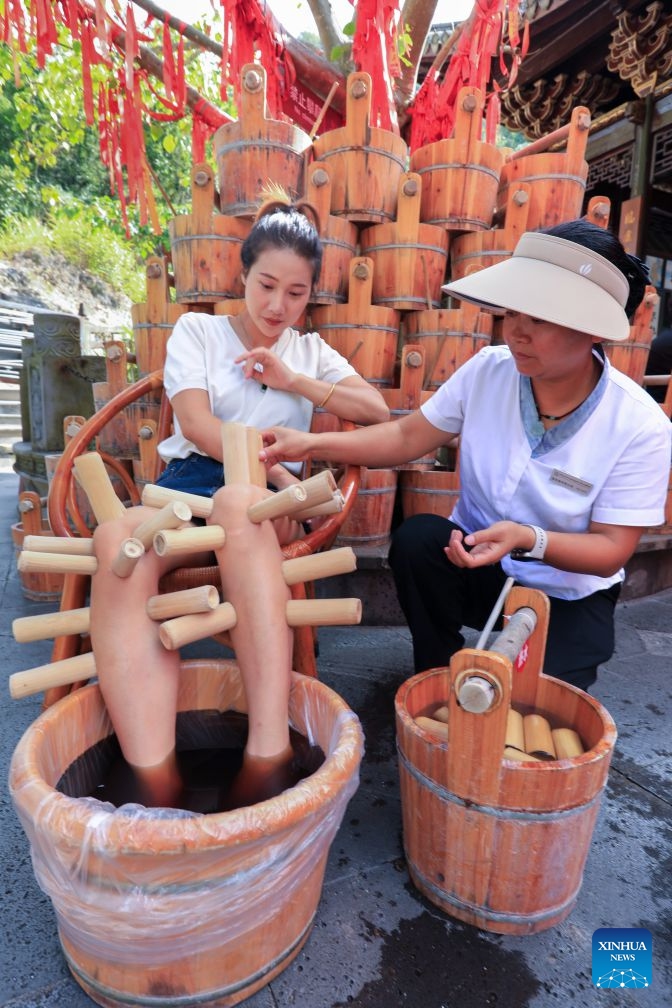 A tourist experiences a therapy at a hot spring scenic area in Tengchong of Baoshan City, southwest China's Yunnan Province, Sept. 23, 2026. In recent years, Baoshan has been developing wellness tourism around its abundant hot spring resources, attracting visitors from neighboring cities and other parts of China. (Photo by Gong Zujin/Xinhua)