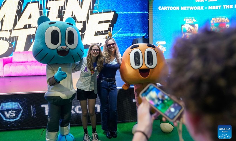 People pose for photos with performers at Comic Con Africa 2026 in Johannesburg, South Africa, Sept. 25, 2026. The event is held here from Sept. 24 to 27. (Photo by Shiraaz Mohamed/Xinhua)