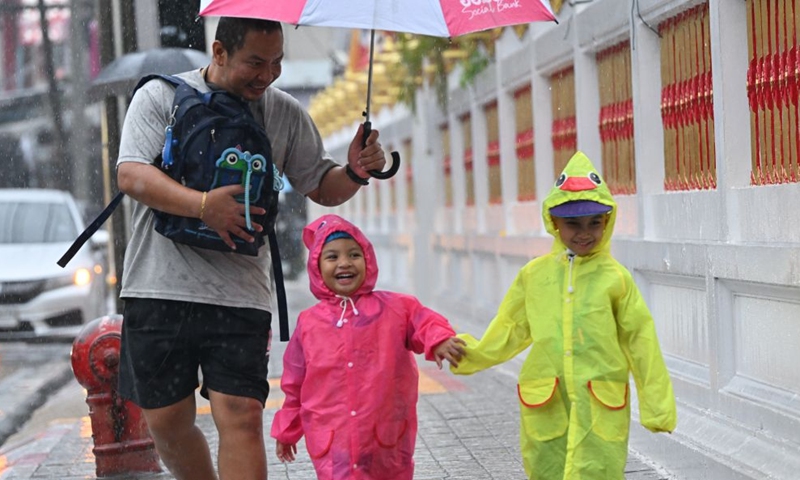 Pedestrians walk on a street in the rain in Bangkok, Thailand, on Sept. 25, 2026. The Thai Meteorological Department has issued a warning of heavy rain in Greater Bangkok and other provinces across Thailand, due to a strong low-pressure system combined with seasonal monsoon patterns. (Xinhua/Rachen Sageamsak)