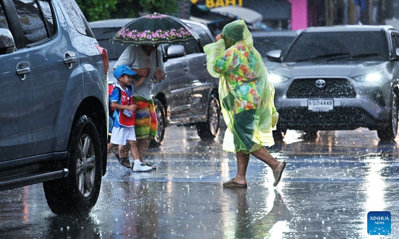 Pedestrians cross a street in the rain in Bangkok, Thailand, on Sept. 25, 2026. The Thai Meteorological Department has issued a warning of heavy rain in Greater Bangkok and other provinces across Thailand, due to a strong low-pressure system combined with seasonal monsoon patterns. (Xinhua/Rachen Sageamsak)