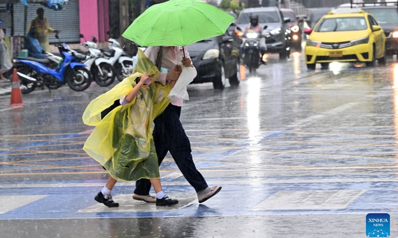 Pedestrians cross a street in the rain in Bangkok, Thailand, on Sept. 25, 2026. The Thai Meteorological Department has issued a warning of heavy rain in Greater Bangkok and other provinces across Thailand, due to a strong low-pressure system combined with seasonal monsoon patterns. (Xinhua/Rachen Sageamsak)