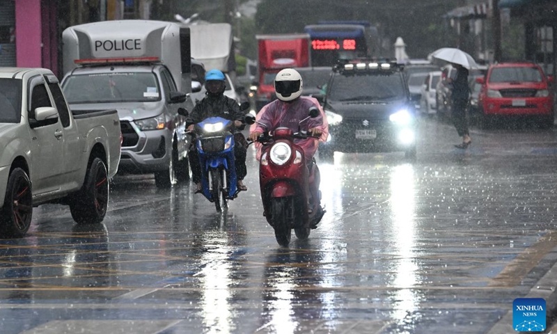 People ride motorcycles in the rain in Bangkok, Thailand, on Sept. 25, 2026. The Thai Meteorological Department has issued a warning of heavy rain in Greater Bangkok and other provinces across Thailand, due to a strong low-pressure system combined with seasonal monsoon patterns. (Xinhua/Rachen Sageamsak)