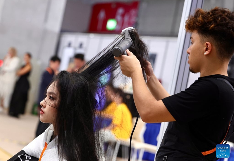 A contestant participates in the hairdressing event during the 48th WorldSkills Competition in Shanghai, east China, Sept. 26, 2026. The 48th WorldSkills Competition opened in Shanghai on Tuesday evening, with 1,385 competitors from 68 countries and regions vying in 64 skill events.
China has sent 71 competitors, who will compete in all 64 events, covering six sectors -- transportation and logistics, construction and building technology, manufacturing and engineering technology, information and communication technology, creative arts and fashion, and social and personal services, according to organizers.
The competition brings together young skilled professionals from around the world to showcase their expertise and exchange experience. Photo: Xinhua