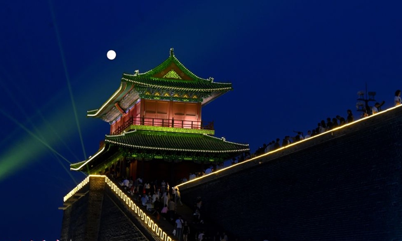People admire the mid-autumn moon at Zhengding ancient town in Shijiazhuang, north China's Hebei Province, Sept. 25, 2026. The Mid-Autumn Festival falls on Sept. 25 this year. (Photo by Chen Qibao/Xinhua)
