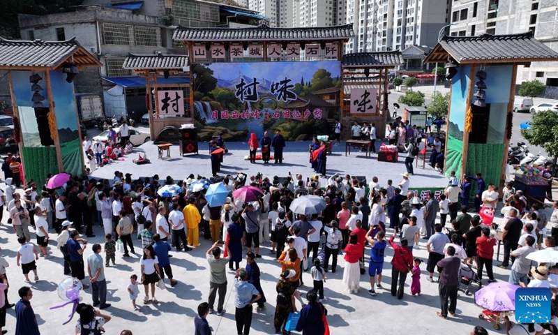 A drone photo taken on Sept. 25, 2026 shows tourists enjoying a performance in Shiqian County, Tongren City, southwest China's Guizhou Province. Chinese people are on a three-day holiday for the Mid-Autumn Festival, which fell on Sept. 25 this year. (Photo by Wu Jian/Xinhua)