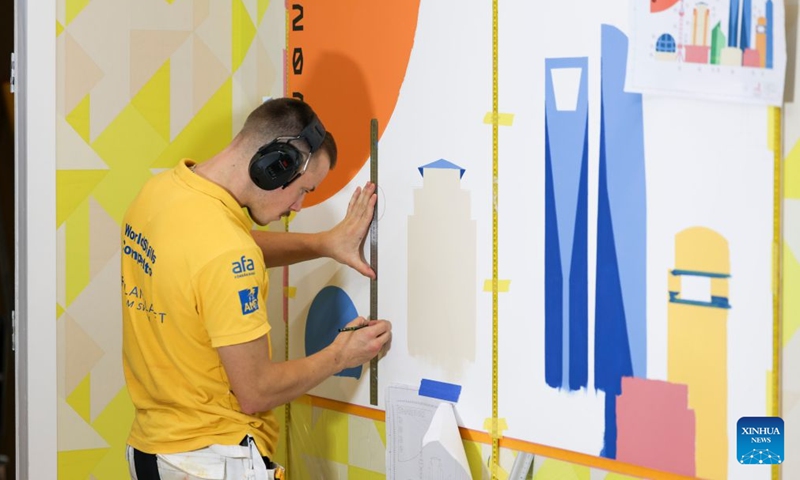 A Swedish contestant participates in the painting and decorating event during the 48th WorldSkills Competition in Shanghai, east China, Sept. 25, 2026. The 48th WorldSkills Competition is held here from Sept. 22 to 27. Contestants around the world have focused on the competition, demonstrating the craftsmanship spirit through meticulous practical work. (Xinhua/Wang Xiang)