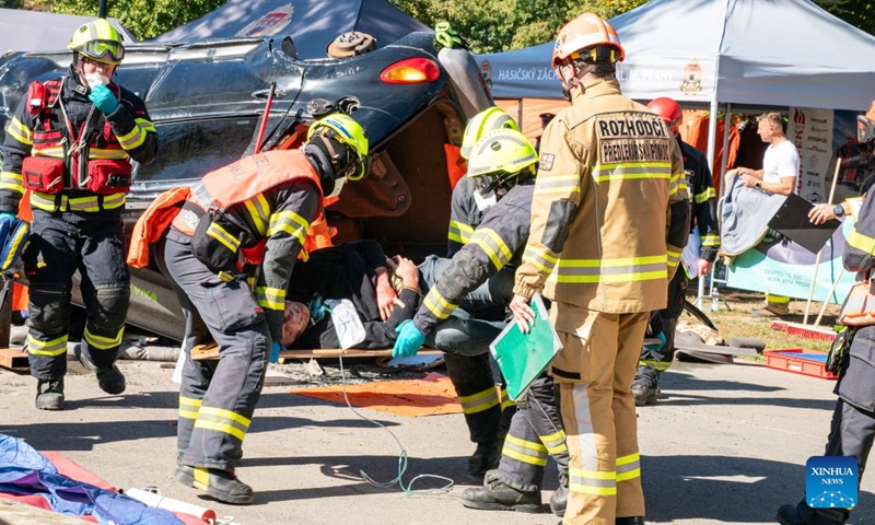 Rescuers demonstrate an emergency rescue during the Heroes' Day event in Prague, the Czech Republic, Sept. 26, 2026. The event was held in Prague on Saturday, bringing together firefighters, police officers, emergency medical personnel and representatives of other rescue, security and organizations. They showcased vehicles and equipment, demonstrated emergency response skills, and offered interactive activities to raise public preparedness for emergencies. (Photo by Dana Kesnerova/Xinhua)