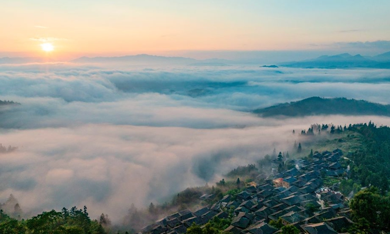An aerial drone photo taken on Sept. 26, 2026 shows the sunrise scenery seen from Basha Village in Congjiang County of Qiandongnan Miao and Dong Autonomous Prefecture, southwest China's Guizhou Province. (Photo by Wu Dejun/Xinhua)