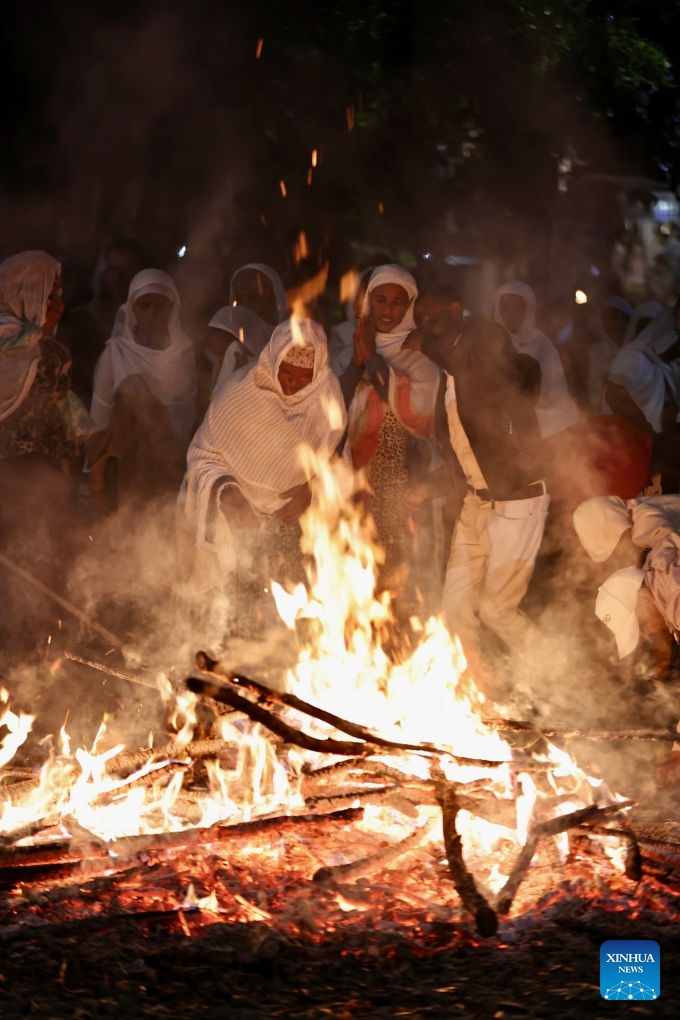 People gather around a bonfire to celebrate the Meskel festival in Addis Ababa, capital of Ethiopia, Sept. 26, 2026. Meskel is a major religious festival in Ethiopia that includes the burning of a large bonfire, known as Demera. (Xinhua/Geng Xinning)