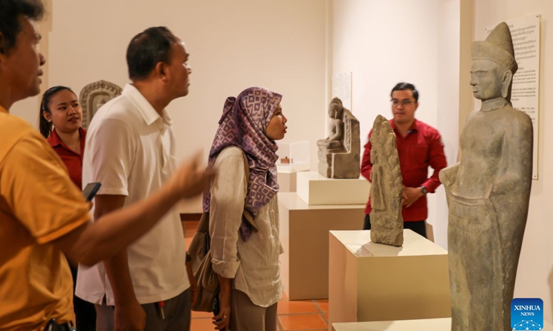 People visit an exhibition showcasing Buddha statues and fragments at the Preah Norodom Sihanouk-Angkor Museum in Siem Reap province, Cambodia, on Sept. 15, 2026. A collection of 274 Angkor-era Buddha statue fragments is now on public display at the Preah Norodom Sihanouk-Angkor Museum in Northwest Cambodia's Siem Reap province, the APSARA National Authority (ANA) said in a news release on Friday. (ANA/Handout via Xinhua)