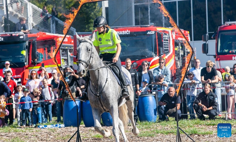 A mounted police officer demonstrates her horsemanship during the Heroes' Day event in Prague, the Czech Republic, Sept. 26, 2026. The event was held in Prague on Saturday, bringing together firefighters, police officers, emergency medical personnel and representatives of other rescue, security and organizations. They showcased vehicles and equipment, demonstrated emergency response skills, and offered interactive activities to raise public preparedness for emergencies. (Photo by Dana Kesnerova/Xinhua)