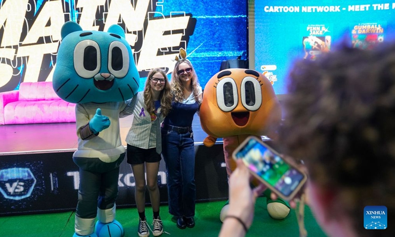 People pose for photos with performers at Comic Con Africa 2026 in Johannesburg, South Africa, Sept. 25, 2026. The event is held here from Sept. 24 to 27. (Photo by Shiraaz Mohamed/Xinhua)