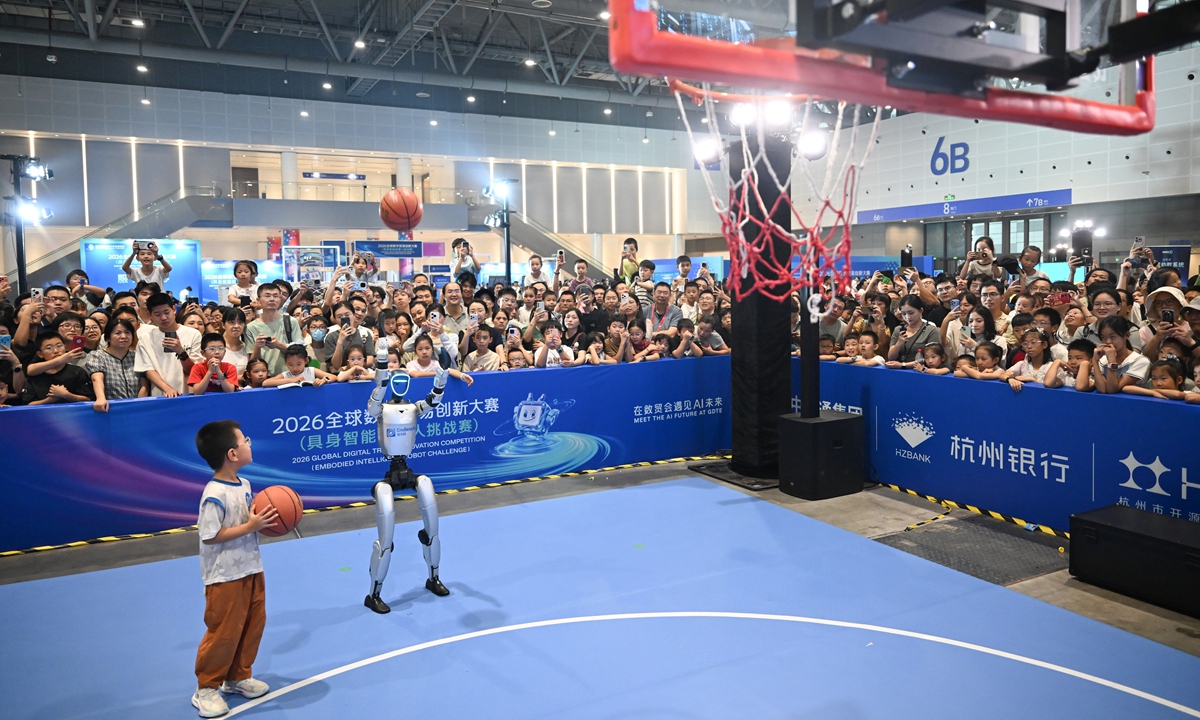 A humanoid robot competes in a basketball shooting contest with a child during a public experience event at the 2026 Global Digital Trade Innovation Competition (Embodied Intelligence Robot Challenge) in Hangzhou, East China's Zhejiang Province, on September 26, 2026. The competition was an important concurrent event of the Fifth Global Digital Trade Expo, which concluded on Sunday. Photo: VCG