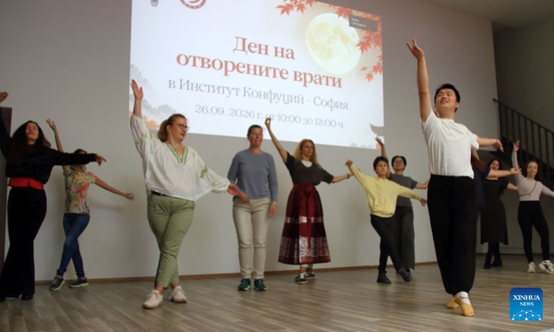 A Chinese instructor teaches people to dance during an Open Day event hosted by the Confucius Institute in Sofia, Bulgaria, Sept. 26, 2026. The Confucius Institute in Sofia held art workshops during an Open Day event on Saturday. (Photo by Marian Draganov/Xinhua)