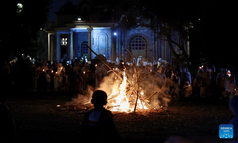 People gather around a bonfire to celebrate the Meskel festival in Addis Ababa, capital of Ethiopia, Sept. 26, 2026. Meskel is a major religious festival in Ethiopia that includes the burning of a large bonfire, known as Demera. (Xinhua/Geng Xinning)