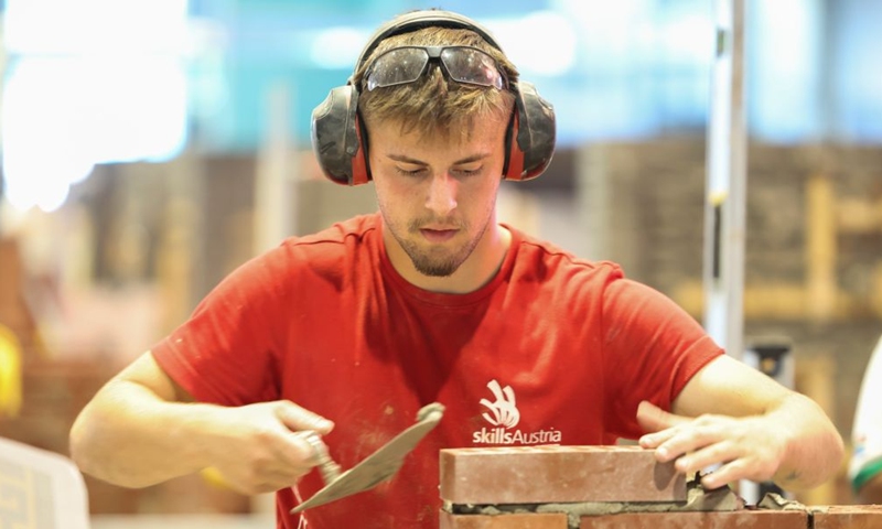 An Austrian contestant participates in the bricklaying event during the 48th WorldSkills Competition in Shanghai, east China, Sept. 25, 2026. The 48th WorldSkills Competition is held here from Sept. 22 to 27. Contestants around the world have focused on the competition, demonstrating the craftsmanship spirit through meticulous practical work. (Xinhua/Wang Xiang)