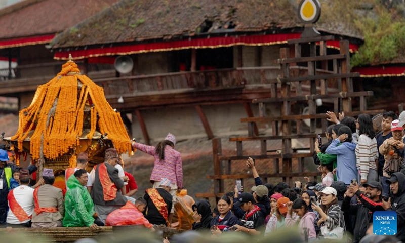 People participate in a chariot procession during the Indra Jatra festival in Kathmandu, Nepal, Sept. 25, 2026. The eight-day festival is celebrated to honor Indra, the god of rain. (Photo by Sulav Shrestha/Xinhua)