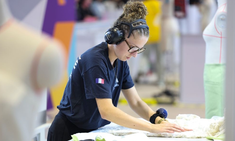 A French contestant participates in the fashion technology event during the 48th WorldSkills Competition in Shanghai, east China, Sept. 25, 2026. The 48th WorldSkills Competition is held here from Sept. 22 to 27. Contestants around the world have focused on the competition, demonstrating the craftsmanship spirit through meticulous practical work. (Xinhua/Wang Xiang)