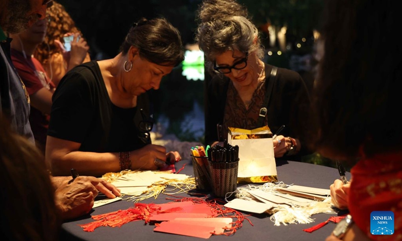 Visitors write wishes on cards during a Mid-Autumn Festival celebration in San Marino, Los Angeles County, Southern California, the United States, on Sept. 25, 2026.(Photo by Zeng Hui/Xinhua)