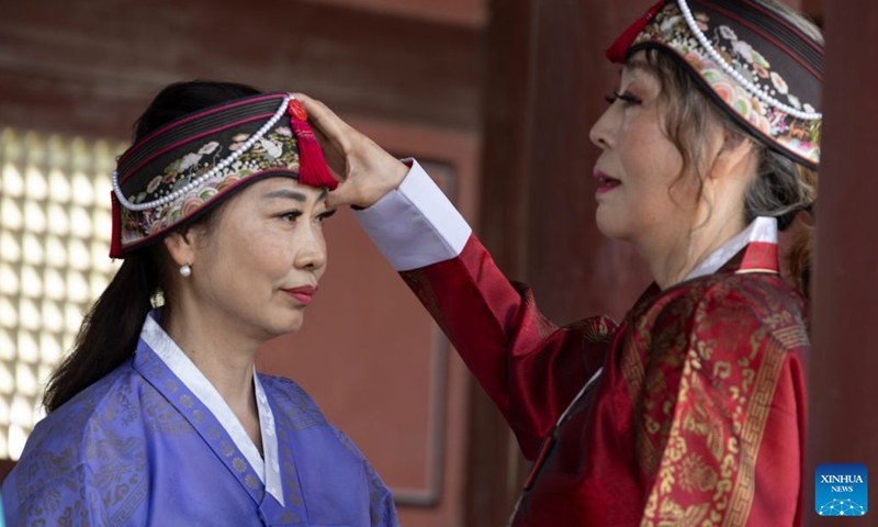People wearing traditional Hanbok pose for photos during the Chuseok holiday at the Gyeongbokgung Palace in Seoul, South Korea, Sept. 26, 2026. (Photo by Jun Hyosang/Xinhua)
