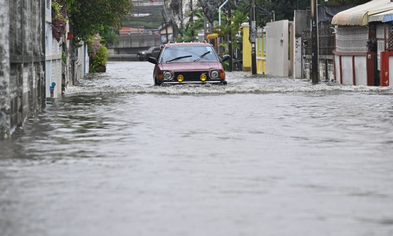 A vehicle drives through floodwaters in Bangkok, Thailand, Sept. 26, 2026. All 50 districts of Bangkok have been declared flood disaster areas, according to a statement issued Saturday by the city's disaster prevention and mitigation command and signed by Bangkok Governor Chadchart Sittipunt. (Xinhua/Rachen Sageamsak)