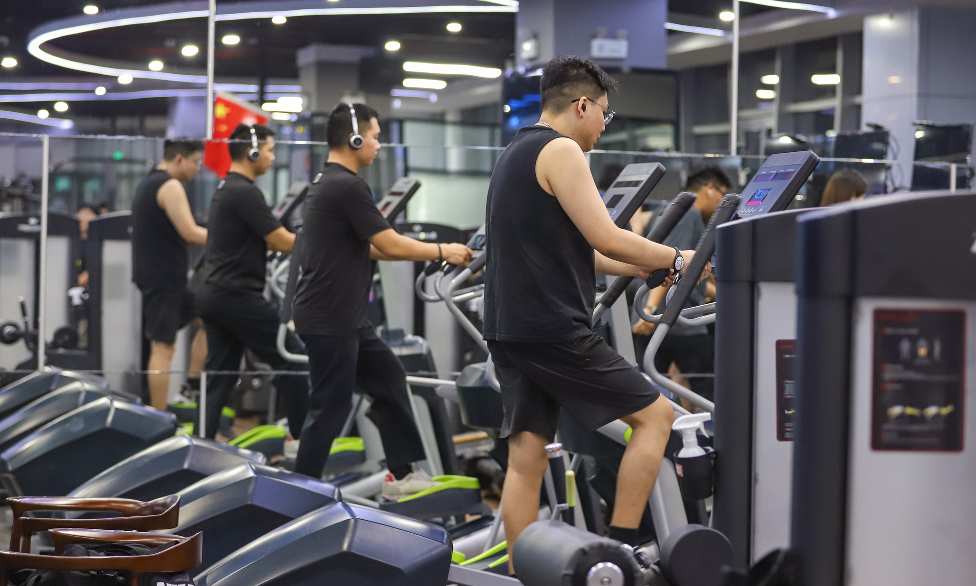 People exercise on treadmills at a gym in Beijing. Photo: VCG