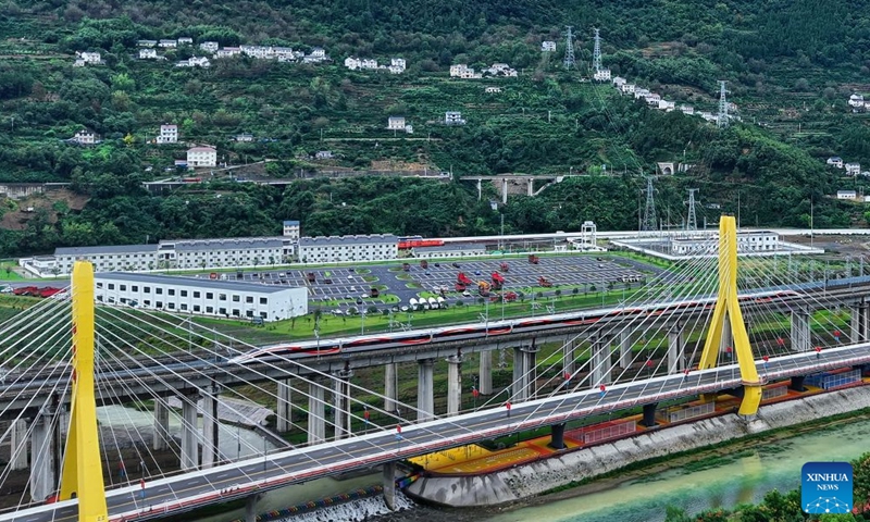 A drone photo taken on Sept. 28, 2026 shows the first train of Yichang-Xingshan high-speed railway, G6888, departing from Xingshan Railway Station in Xingshan County, central China's Hubei Province. The 101-kilometer Yichang-Xingshan high-speed railway officially entered service on Monday. The railway, with a designed speed of 350 kilometers per hour, is an important part of the country's high-speed rail network. (Photo by Zhang Yali/Xinhua)