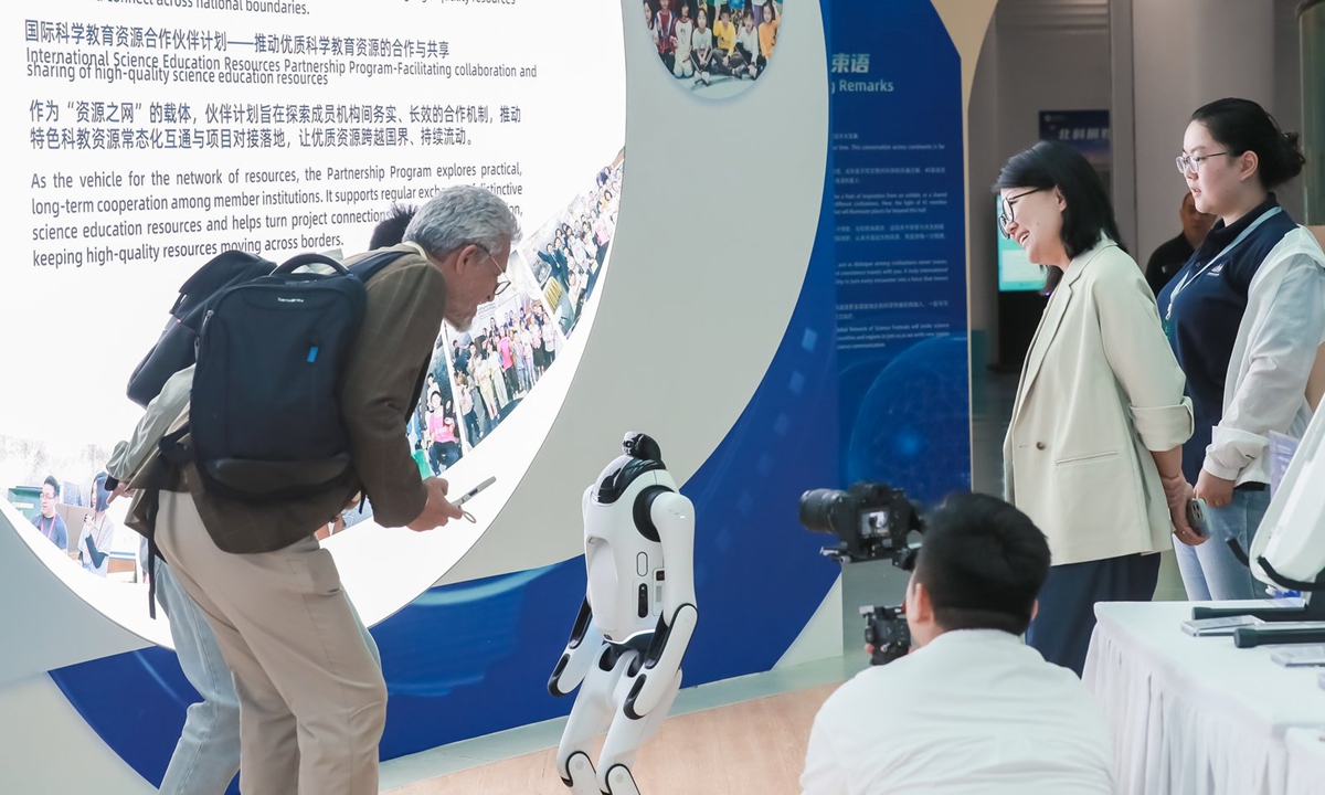 Visitors interact with a robot at the Science Education Exhibition Area of the 2026 Beijing International Week for Science Literacy.  Photo: Courtesy of the organizers