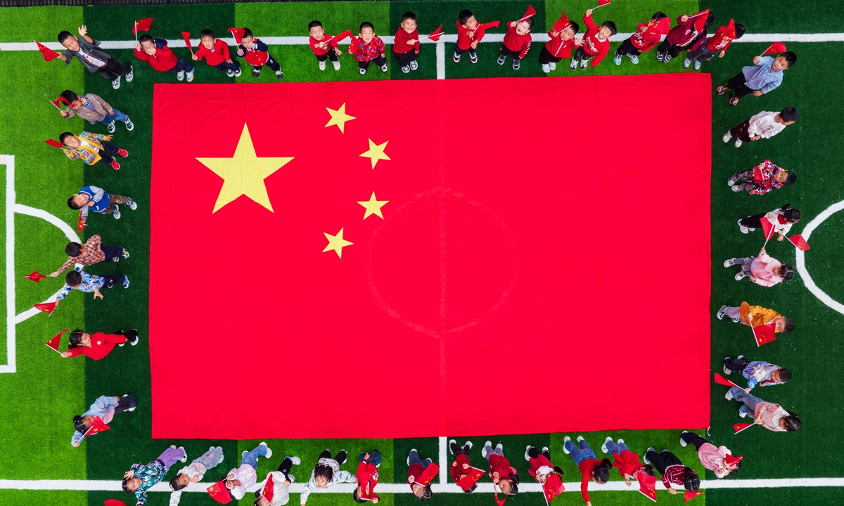 Children pose for a drone photo with a large Chinese national flag at a kindergarten in Baokang County, Xiangyang, Central China's Hubei Province on September 29, 2026, celebrating China's upcoming National Day. Photo: IC