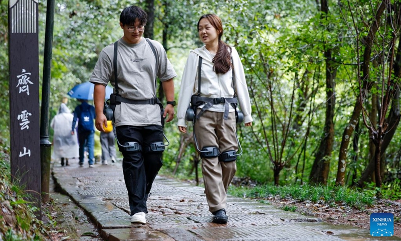 Tourists wearing exoskeleton robots hike in the Qiyun Mountain scenic area of Xiuning County, Huangshan City, east China's Anhui Province, Oct. 2, 2026.
The Qiyun Mountain scenic area offers exoskeleton robot rentals during the National Day holiday to help visitors hike with less effort.
The lightweight, easy-to-use devices sense body movements, providing uphill assistance and downhill cushioning to protect knees and reduce leg strain.
With a growing number of hikers in recent years, the area now offers over 20 such robots, using technology to deliver a smarter mountain climbing experience. Photo: Xinhua