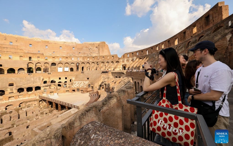 A Chinese tourist takes photos of the Colosseum in Rome, Italy, Oct. 4, 2026. (Xinhua/Li Jing)