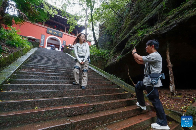 Tourists wearing exoskeleton robots hike in the Qiyun Mountain scenic area of Xiuning County, Huangshan City, east China's Anhui Province, Oct. 2, 2026.
The Qiyun Mountain scenic area offers exoskeleton robot rentals during the National Day holiday to help visitors hike with less effort.
The lightweight, easy-to-use devices sense body movements, providing uphill assistance and downhill cushioning to protect knees and reduce leg strain.
With a growing number of hikers in recent years, the area now offers over 20 such robots, using technology to deliver a smarter mountain climbing experience. Photo: Xinhua